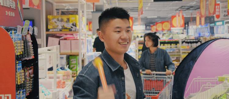 Shopper pushing a cart while holding multiple coupons, illustrating how to stack retail coupons in Canada