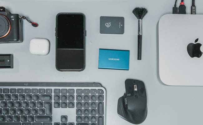 Assorted office supplies and tech gadgets on a Canadian workspace desk for Staples savings