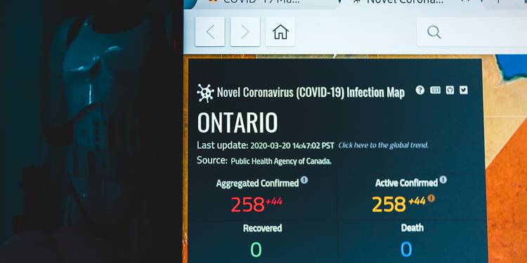Laptop displaying a Canadian price alert notification with a downward graph trend
