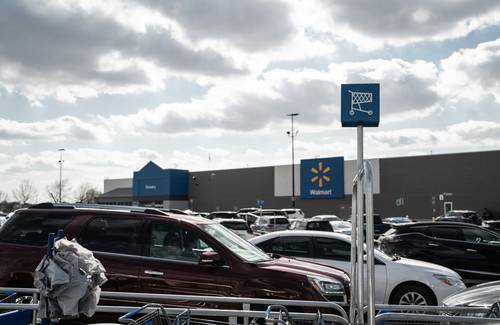 Walmart Canada clearance endcap with yellow tags and shoppers looking for deals