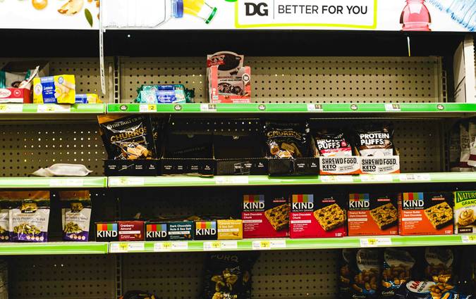 Canadian Walmart store aisle with yellow clearance signs and shoppers browsing discounted products