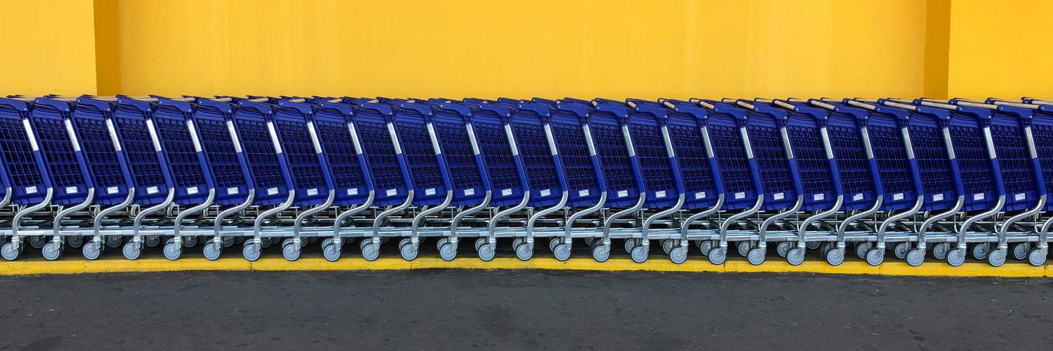 Walmart store exterior at dusk with rows of shopping carts in Canada