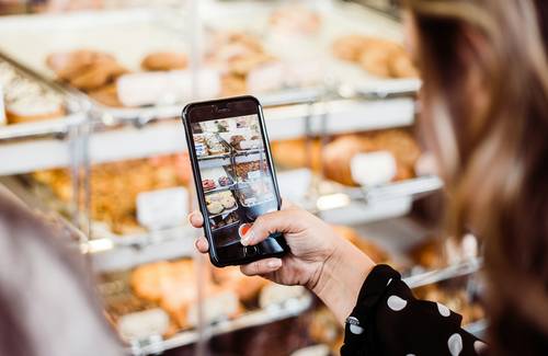 Digital coupons being stacked on a Canadian shopper's smartphone for grocery savings